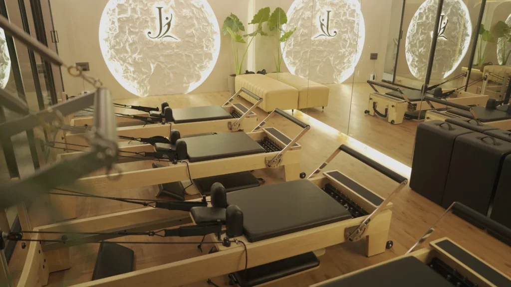 Backlit J Pilates logo wall at the Ghansoli studio