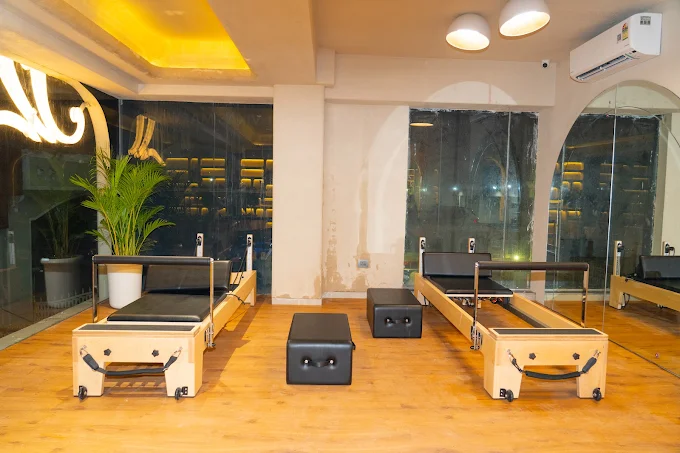 Reformer bay with glass partitions at J Pilates Sanpada
