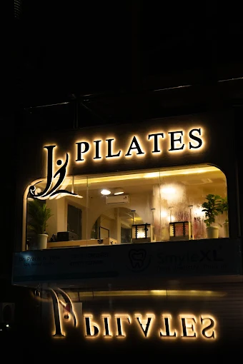 Illuminated J Pilates storefront at night in Sanpada